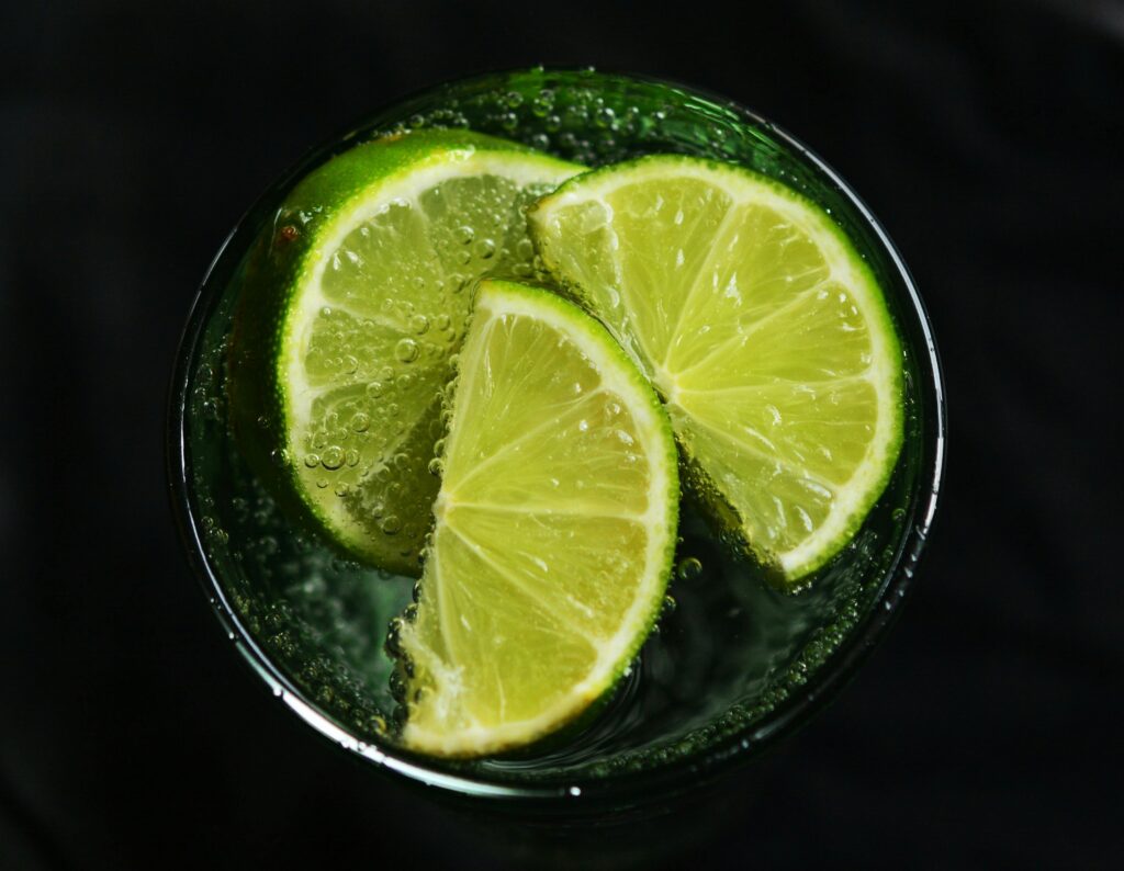 pexels-photo-357577-357577 Close-up of fresh lime slices in a glass of sparkling water, refreshing concept.